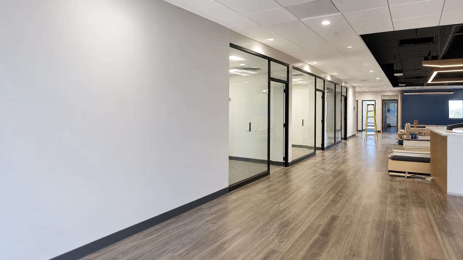 Commercial tenant improvement suite with practical finishes, lighting, flooring, ceiling work, and turnover readiness.